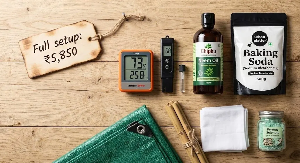 Flat lay of products used on Mumbai balcony — ThermoPro hygrometer, pH meter, Chipku neem oil, baking soda, shade cloth, ferrous sulphate packet, bamboo stakes, white cloth wrapping